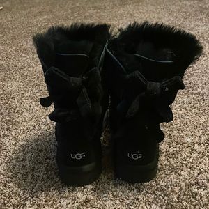 I am selling black boots UGGs with bows on the back.